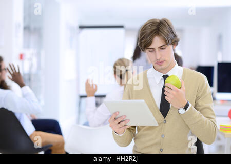 Portrait of confident businessman using digital tablet while colleague in background Stock Photo