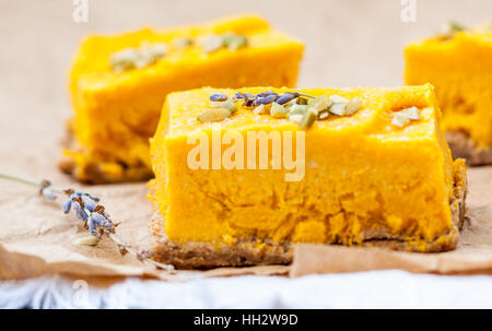 Slices of raw vegan pumpkin cheesecake. Love for a healthy raw desserts concept. Stock Photo