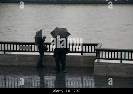 London, UK. 16th Jan, 2017. Tourists take pictures on London riverside on a wet rainy morning in the capital Credit: amer ghazzal/Alamy Live News Stock Photo