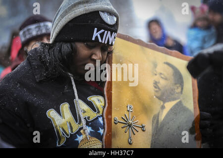 Denver, USA. 16th Jan, 2017. Bridget Johnson holds a sign while a prayer is recited at the 2017 Dr. Martin Luther King Parade in Denver. The event featured a march and parade where city officials, politicians, and community members gathered to celebrate the legacy of Dr. Martin Luther King, and voice their opinion on social issues. Credit: Eliott Foust/ZUMA Wire/Alamy Live News Stock Photo