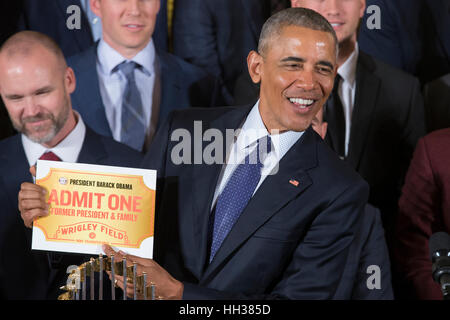 Washington, USA. 16th January, 2017. US President Barack Obama holds a pass to Wrigley Field presented to him during an event held to welcome the Chicago Cubs to the White House, to celebrate their 2016 World Series victory. Credit: Michael Reynolds/Pool via CNP /MediaPunch Stock Photo