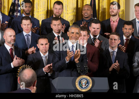 Washington, USA. 16th January, 2017. US President Barack Obama (C) applauds at an event held to welcome the Chicago Cubs to the White House to celebrate their 2016 World Series victory. Credit: Michael Reynolds/Pool via CNP /MediaPunch Stock Photo