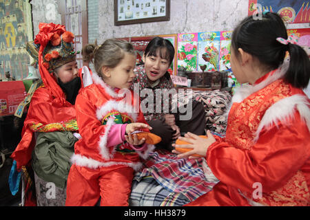 Xi'an, China. 15th January, 2017. **EDITORIAL USE ONLY. CHINA OUT** The Italian girl Gemma wearing Chinese traditional clothes experiences folk customs of Spring Festival with her Chinese friends in Xi'an, capital of northwest China's Shaanxi Province. Gemma now lives in Xi'an with her parents because of their jobs there. Credit: SIPA Asia/ZUMA Wire/Alamy Live News Stock Photo