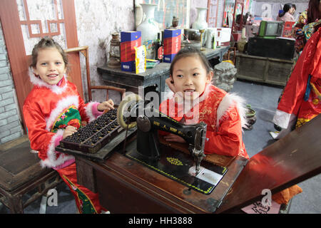 Xi'an, China. 15th January, 2017. **EDITORIAL USE ONLY. CHINA OUT** The Italian girl Gemma wearing Chinese traditional clothes experiences folk customs of Spring Festival with her Chinese friends in Xi'an, capital of northwest China's Shaanxi Province. Gemma now lives in Xi'an with her parents because of their jobs there. Credit: SIPA Asia/ZUMA Wire/Alamy Live News Stock Photo