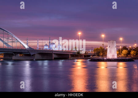 Abu Dhabi landmarks.  Maqta fort and bridge in Abu Dhabi at sunset with Sheikh Zayed Grand Mosque in background Stock Photo