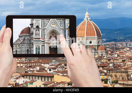 travel concept - tourist photographs walls of Duomo Santa Maria del Fiore in Florence city on tablet in Italy Stock Photo