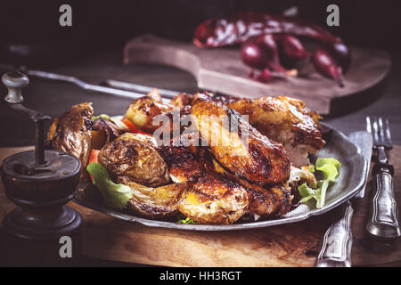 Slices of grilled chicken on plate rustic Stock Photo