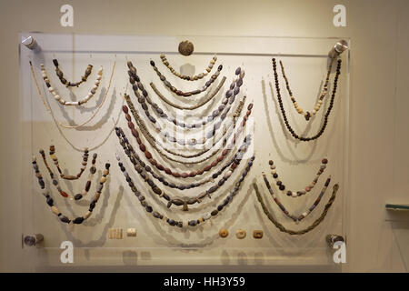 Glass and clay beads of different shapes and colors displayed in