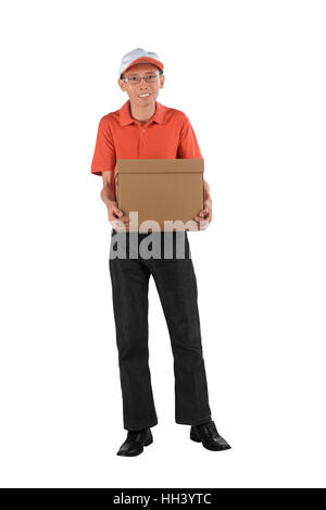 Young asian courier holding a cardboard box while standing isolated against white background Stock Photo