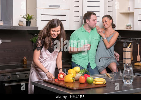 Three friends having fun in the kitchen Stock Photo