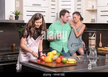 Three friends having fun in the kitchen Stock Photo