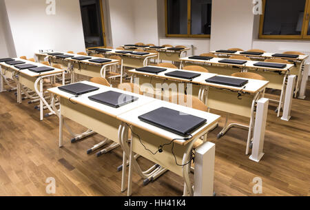 Modern computer classroom with laptop computers, tables and chairs. Stock Photo