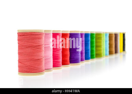 Different color Sewing Threads on a roll. Isolated on white background. Sewing accessories for hobby of professional fashion use. Stock Photo