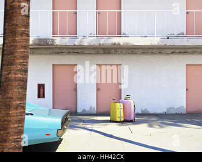 Luggage beside parked car outside motel. 3d rendering Stock Photo