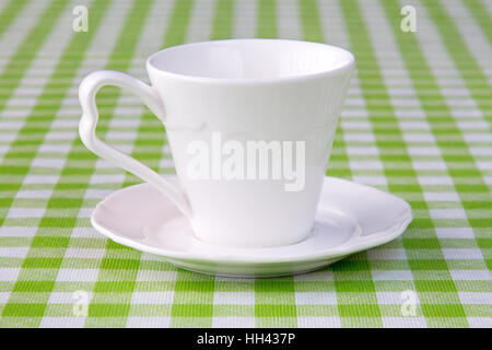 Empty cup on the checkered tablecloth texture Stock Photo