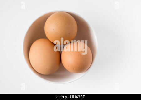 top view of three eggs in white cup Stock Photo