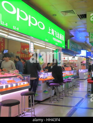 People shop at OPPO mobile phone shop Bu Ye Cheng Commercial market in Shanghai China. OPPO is Electronics Corp is a Chinese electronics manufacturer Stock Photo