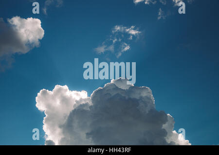 Sun rays shining through beautiful cumulonimbus clouds Stock Photo
