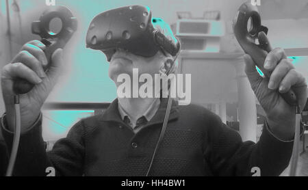 Man with the VIVE headset exploring the world with the newly released Google Earth  VR to give a virtual reality experience - Bath, England, UK Stock Photo