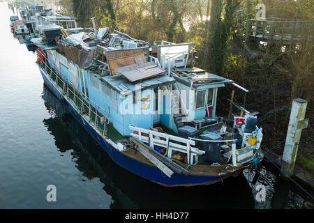 Popularly described as a ' slum ' boat, house boats are pictured moored at Teddington Lock, on the River Thames. West London. UK Stock Photo