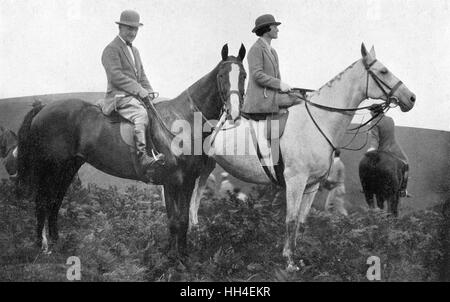 Cecil Aldin (1870-1935), British artist and illustrator, seen here on horseback with Lady Violet Munnings, taking part in a hunt with the Devon and Somerset Staghounds. Stock Photo