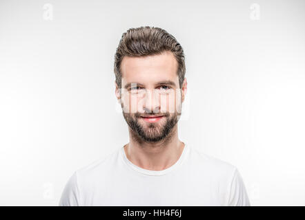 Smiling young man looking at the camera on white Stock Photo