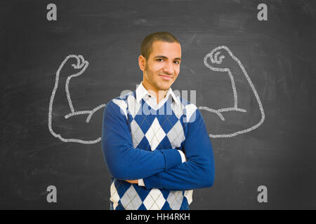 Successful and powerful student with muscles of chalk on blackboard as motivation concept Stock Photo