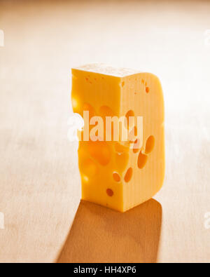 ыгтPiece of cheese on wooden background. Stock Photo