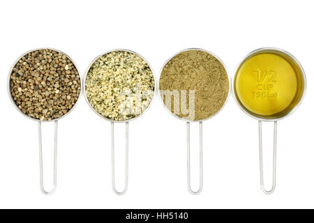 Hemp super food ingredients with seed, hulled seeds, powder and oil in metal measuring scoops oover white background. Left to right. Stock Photo