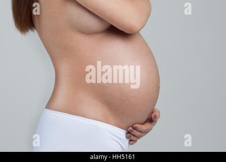 Belly of a pregnant woman isolated on white background Stock Photo