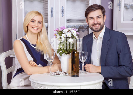 Beautiful Young couple having fun together in valentine days. drinking white wine and enjoying their good romantic dating. Stock Photo