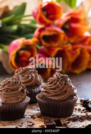 Delicious Mothers day  chocolate cupcakes  with spring tulips Stock Photo