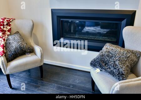 Chairs surrounding a fireplace in a modern home