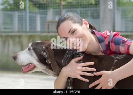 shelter keeper loves her residents Stock Photo