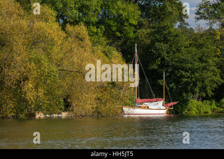A sailboat moored on the River Thames near Hambleden Lock, in early autumn, Chilterns, Buckinghamshire, England