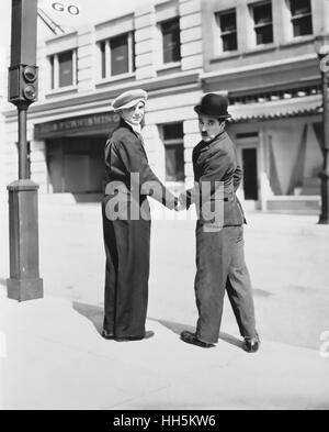 CHARLES CHAPLIN at right on the set of Modern Times in 1935 with Jackie Coogan Stock Photo