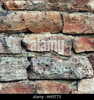 Stone wall macro closeup, stonewall pattern background, old aged weathered red and grey grunge limestone dolomite calcium carbonate hard sedimentary Stock Photo