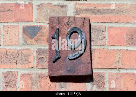 House Number 19 sign on wall Stock Photo