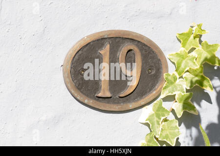House Number 19 sign on wall Stock Photo