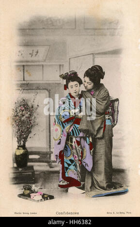 Japan - A Geisha whispers a secret to another fellow Geisha Stock Photo