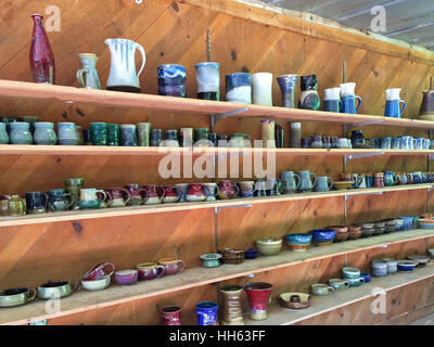 Shelves filled with pottery on sale at Mark of the Potter in Batesville, GA. Stock Photo