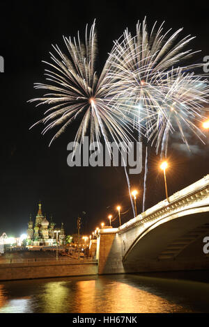 Huge Sparkling White Balls Over St. Basil's Slope. Fireworks  over Bolshoi Moskvoretsky Bridge during a day of Moscow City. Stock Photo