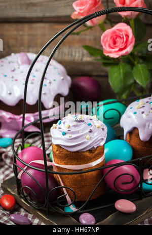 Delicious homemade holiday Easter cakes and colored eggs around Stock Photo