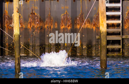 an image of a bubbler, de-icer, circulator, aerator at work in a marina, protecting docks in a marine envioment Stock Photo