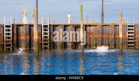 an image of a bubbler, de-icer, circulator, aerator at work in a marina, protecting docks in a marine envirorment Stock Photo