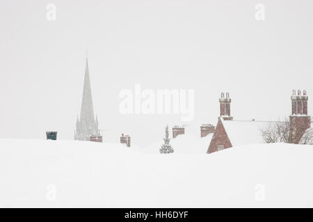 SURREY, UK The spire of St Martin's church emerges from the top of a hill in snow. Stock Photo