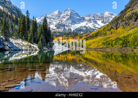 Maroon Bells and Maroon Lake - A wide-angle autumn view of snow coated Maroon Bells reflecting in crystal clear Maroon Lake. Stock Photo