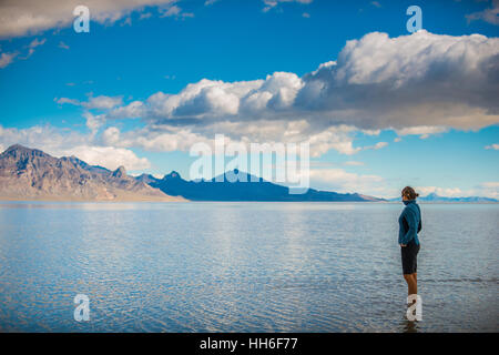 Tourist standing in a shallow water Bonneville Salt Flats Utah Stock Photo
