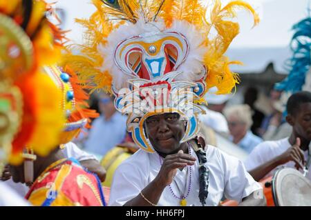 drummer in carnival dress in a Junkanoo band playing in a street parade on Nassau Bahamas Stock Photo
