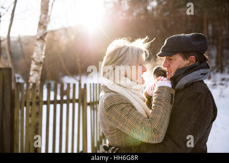 Beautiful senior couple on a walk on sunny winter day